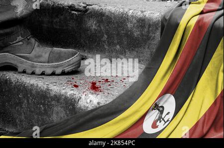 Das Bein des Militärs steht auf der Stufe neben der Flagge Ugandas, dem Konzept des militärischen Konflikts Stockfoto