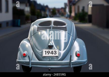 VW Käfer von 1943 in der Rückansicht, Composite in einer verschwommenen deutschen Wohnanlage, mit Brezelfenster und Zentralabgasanlage in Wolfsburg, Deutschland, SE Stockfoto