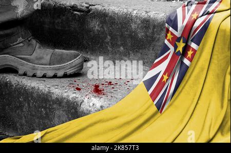 Das Bein des Militärs steht auf der Stufe neben der Flagge von Niue, dem Konzept des militärischen Konflikts Stockfoto