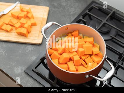 Kürbissuppe in einem Topf auf einem Gasherd zubereiten Stockfoto