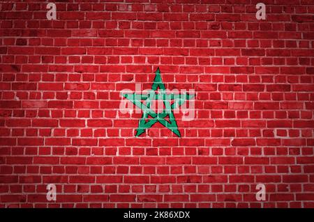 An image of the Morocco flag painted on a brick wall in an urban location Stockfoto
