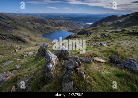 Wanderer auf Little How Crags über Hebeln Wasser auf dem Old man of Coniston, Lake District National Park, UNESCO, Cumbria, England Stockfoto