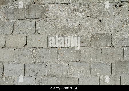 Betonwand Hintergrund Nahaufnahme ( Muster der grauen Wand aus Betonsteinen ) Stockfoto