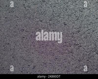 Dunkelgraue Textur von Asphalt für eine Tapete oder einen Hintergrund Stockfoto