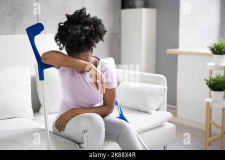 Gebrochenes Bein Bei Der Wiederherstellung Der Besetzung. Frau Mit Verletzung Auf Dem Sofa Stockfoto