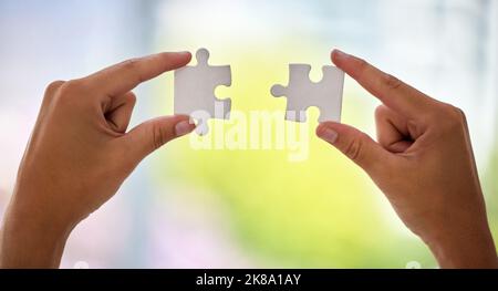 Wenn das Puzzleteil passt... eine unkenntliche Geschäftsfrau, die ein Puzzle vervollständigt. Stockfoto