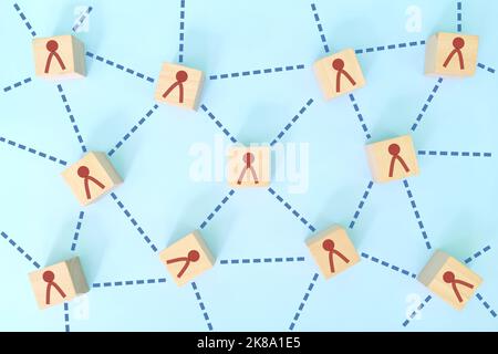 Soziale Verbindungen, Teamarbeit und Vernetzung im Geschäftskonzept. Zusammengeschaltete Holzblöcke flach Lay Zusammensetzung auf blauem Hintergrund. Stockfoto