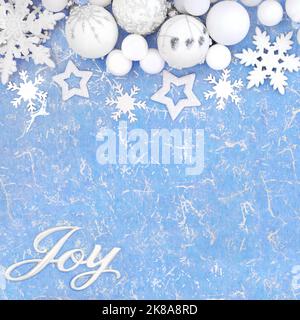 Weihnachtsfreude-Schild mit Schneeflocken und mattierten Baumdekorationen auf blauweißem Hintergrund. Weihnachten festliches Design für Winter und Neujahr. Stockfoto