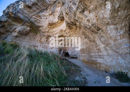 Blick auf den Eingang einer Höhle in der Schlucht zwischen der Stadt Miera und dem Naturpark Murgia Timone Stockfoto