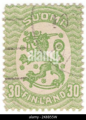 FINNLAND - 1923: Eine grüne Briefmarke mit 30 Pennien, die finnische heraldische Symbole zeigt: Gekrönter Löwe, Schwert, Säbel und stilisierte Blumen in einem ovalen Rahmen Stockfoto