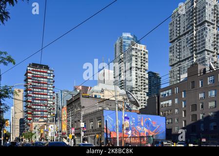 Toronto, Kanada - 11. August 2022: Die trendige Queen Street West in der Nähe der McCaul Street, inklusive Hochhaus-Apartmenthäusern. Stockfoto