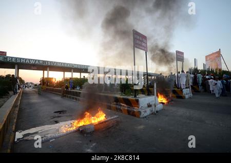 Anhänger der Partei des ehemaligen Premierministers Imran Khan singen Slogans, während sie eine Straße auf der mautpflichtigen autobahn in Peshawar blockieren, als Protest gegen die Entscheidung der Wahlkommission, ihren Führer Khan in Peshawar, Pakistan, zu disqualifizieren. Die pakistanische wahlkommission hat am Freitag den ehemaligen Premierminister Imran Khan vom öffentlichen Amt disqualifiziert, da er ihm unrechtmäßig staatliche Geschenke verkauft und Vermögenswerte verheimlicht hat, sagte sein Sprecher. Dieser Schritt dürfte die anhaltenden politischen Turbulenzen im verarmten Land noch verstärken. (Foto von Hussain Ali/Pacific Press) Stockfoto