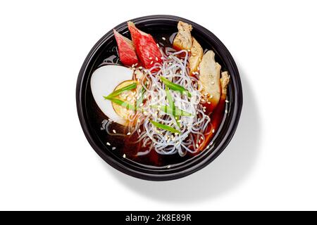 Japanische Suimono-Suppe in Seetang-Brühe mit Lachs, Huhn, Reisnudeln, gekochtem Ei, grünen Zwiebeln und Sesam Stockfoto