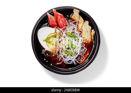 Japanische Suimono-Suppe in Seetang-Brühe mit Lachs, Huhn, Reisnudeln, gekochtem Ei, grünen Zwiebeln und Sesam Stockfoto