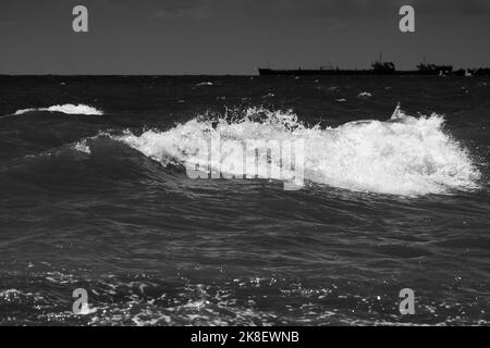 Meereswellen mit Schaum. Schwarz-weiße Strandfotografie. Hochwertige Fotos Stockfoto