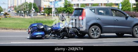 Verkehrsunfall zwischen Elektrofahrrad und Auto, Motorrad fiel auf Asphalt, Augenzeuge Stockfoto