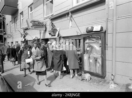 Strømstad, Schweden 6. April 1963. Norweger marschieren am schneidenden Donnerstag in Strømstad ein. Die Tradition begann nach dem Krieg, als Norwegen den größten Teil der Waren vermisste. Die Geschäfte in Norwegen sind am Donnerstag geschlossen, so dass Sie eine Reise nach Schweden Unternehmen müssen, um das Auto oder Boot mit verschiedenen Waren zu füllen. Hier norwegische Kunden, die in Schaufenster schauen, Textilgeschäft. Foto: Ivar Aaserud / Aktuell / NTB Stockfoto