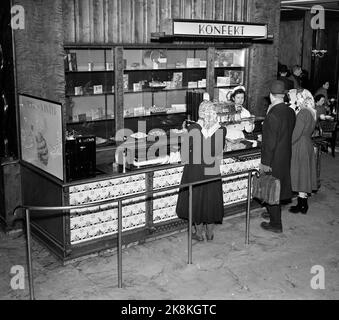 Oslo 19530201 Interieur aus Møllhausen Konditori im Karl Johans Tor. Hier aus dem Süßwarenverkauf. Kunden an der Theke, weibliche Angestellte mit weißer Schürze und Bademantel hinter der Theke. Foto: NTB / NTB Stockfoto