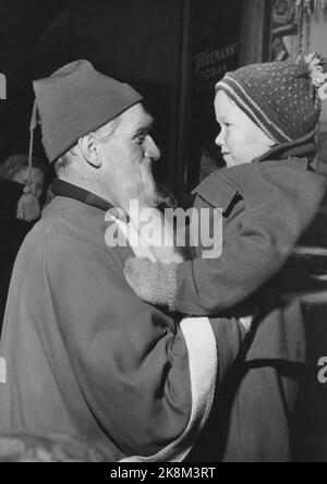 Oslo 195412 - Kinder treffen den Weihnachtsmann. Der kleine Junge wird vom Weihnachtsmann hochgehoben. Snacks. Foto: Aage Storløkken / Aktuell / NTB Stockfoto