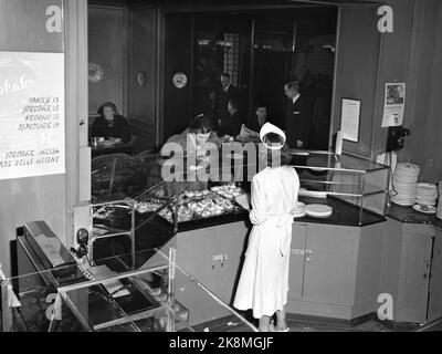 Oslo 19530201 Interieur aus Møllhausen Konditori im Karl Johans Tor. Kunden am Schalter, weibliche Disponenten mit weißen Schürzen und Kappen hinter dem Schalter. Foto: NTB / NTB Stockfoto