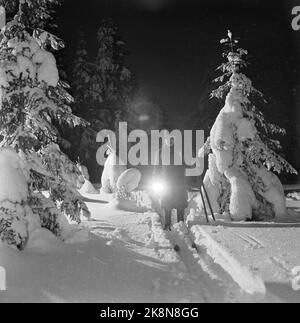 Aurskog 11 February 1956 'Diese Kinder haben 3 Meilen Schulstraße' die jungen Kinder Kjell aus Nybak, Hallvard aus Sinkerud und Marit aus Stenshaugen müssen 6 km allein durch den nächtlichen Schwarzwald laufen, bevor sie den Schulbus in Bekkesaga erreichen. Sie müssen um 5 Uhr aufstehen, um den Bus zu erreichen, der zur Haneborg-Schule in Aurskog fährt. Ganz allein kommt Kjell aus dem dunklen Wald, mit einer Taschenlampe in der Hand. Foto; Sverre A. Børretzen / Aktuell / NTB Stockfoto