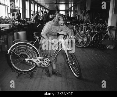 Sandnes 19490415. In Ständen mit 75.000 Fahrrädern. Die Firma Jonas Øgländ in Sandnes, Rogaland, wurde 1868 gegründet. Die Fahrradfabrik Øgländ stellt jährlich 75.000 Fahrräder her, die Hälfte davon wird hier im Werk zusammengestellt, die andere Hälfte wird an Händler verkauft, die sie selbst zusammenstellen oder als Ersatzteile verwenden. Im Jahr 1932 brachten sie das beste Fahrrad auf den Markt - DBS. Die Fabrik hat etwa 400 Arbeiter. Frau in der Arbeit mit Fahrrad. Foto; Sverre A. Børretze / Aktuell / NTB Stockfoto