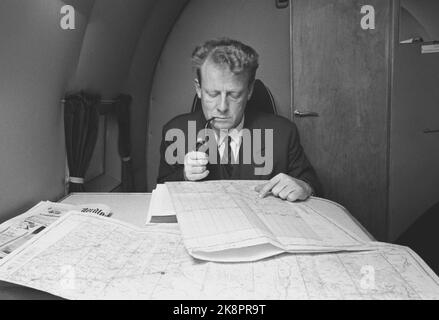 Finmark Dezember 1962. Verteidigungsminister Gudmund Harlem wird an der Grenze zu Jakobselv Weihnachtsgeschenke für die Männer, die die Grenze zur Sowjetunion begeht, halten. Die Reise dauerte 5 Tage und wurde zu einer harten Reise mit Flugzeug, Auto, Boot und Pulk. Auf der Fahrt nach oben raucht Harlem mit der Karte der Gebiete, die er auf der Reise besuchen wollte. Foto: Ivar Aaserud Current / NTB Stockfoto