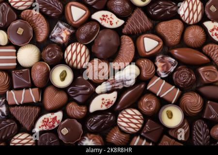 Schokolade Bonbons Hintergrund, süße Lebensmittel mit verschiedenen Füllungen. Stockfoto