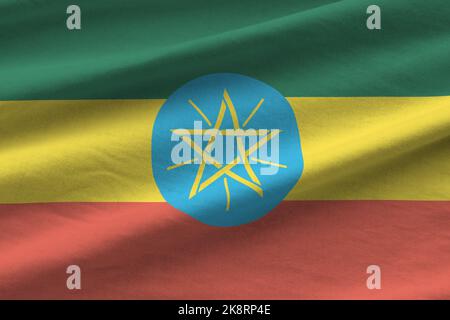 Äthiopien Flagge mit großen Falten winken aus nächster Nähe unter dem Studiolicht drinnen. Die offiziellen Symbole und Farben in Stoff Banner Stockfoto