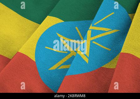 Äthiopien Flagge mit großen Falten winken aus nächster Nähe unter dem Studiolicht drinnen. Die offiziellen Symbole und Farben in Stoff Banner Stockfoto
