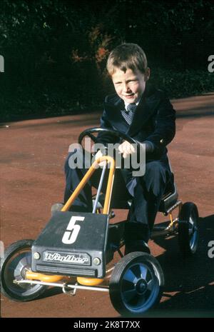 Asker 197909: Die Kronprinzenfamilie in Skaugum, September 1979. Das Kronprinzenpaar und die Kinder, die zu Hause in Skaugum fotografiert wurden. Das Bild: Prinz Haakon Magnus auf seinem Tread im Garten von Skaugum. /Spielzeugautos/ Foto: Bjørn Sigurdsøn / NTB / NTB Stockfoto