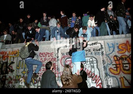 Berlin, Deutschland 19891110 Fall der Berliner Mauer: Am Freitagabend krochen Tausende Menschen die Mauer am Brandenburger Tor in Vest-Berlin hinauf. Foto von Jugendlichen, die die Wand hochklettern. Foto: Jørn H. Moen / NTB gescannt in 60 MB Stockfoto