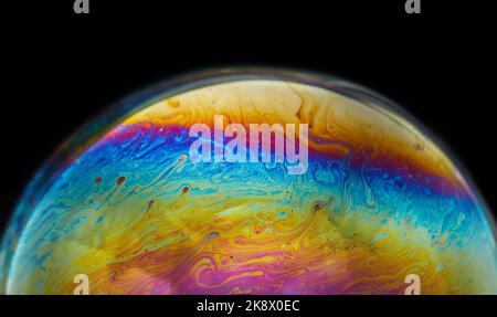 Virtual Reality Raum mit abstrakten multicolor psychedelischen Planeten. Nahaufnahme Seifenblase wie ein außerirdischer Planet auf schwarzem Hintergrund Stockfoto