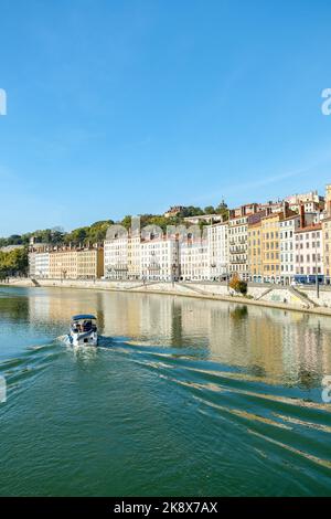 Französische Stadt an einem sonnigen Tag mit einer Straße am Fluss Stockfoto