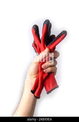 Elektriker-Handschuhe in der Hand isolieren. Selektiver Fokus. Menschen. Stockfoto