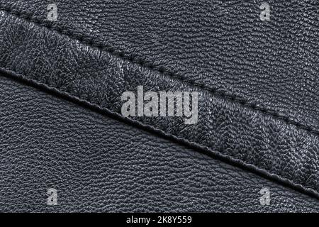 Textur aus schwarzem Leder diagonal mit Doppelnaht genäht Stockfoto