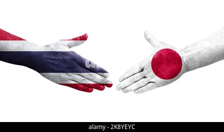 Handschlag zwischen Japan und Thailand Flaggen auf Händen gemalt, isolierte transparente Bild. Stockfoto