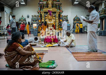 Hinduistische Anhänger rezitieren Tirumuruk???Uppa?ai, ein andachtes tamilisches Gedicht in der Sangam-Literatur, das Lord Murugan gewidmet ist. Diwali, Deepavali oder das Festival of Lights ist ein fünftägiges Fest, das von Millionen von Hindus, Sikhs und Jains weltweit gefeiert wird. Es ist an der Zeit, den Triumph des Guten über das Böse und das Licht über die Dunkelheit zu feiern. In diesem Jahr fällt Diwali auf den 24.. Oktober 2022. Eifrige Anhänger besuchen in der Nacht von Diwali den Murugan-Tempel auf dem Highgate Hill, um Puja- oder Anbetungsrituale zur Andacht an ihre verehrten Gottheiten anzubieten. Stockfoto