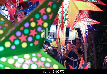 Mumbai, Maharashtra, Indien. 22. Oktober 2022. Ein Mann fotografiert die Laternen, die auf den Straßen von Mumbai zum Verkauf stehen. Diwali wird als Lichterfest gefeiert, Hindus schmücken ihr Zuhause mit irdenen Lampen und bunten Laternen in verschiedenen Formen und Größen. Diwali symbolisiert den Sieg des Lichts über die Dunkelheit. (Bild: © Ashish Vaishnav/SOPA Images via ZUMA Press Wire) Stockfoto