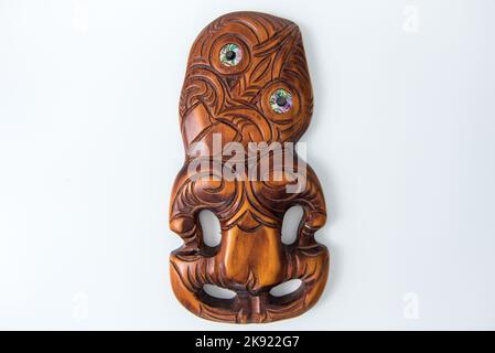 Maori Hei Tiki aus Holz, handgeschnitzt mit Paua-Muschelaugen. Neuseeländische Taonga. Stockfoto