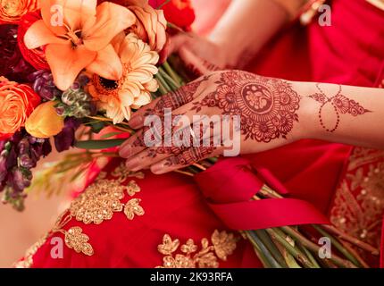 Essentials für die Braut zu sein. Eine unkenntliche Frau mit einem Blumenstrauß vor ihrer Hochzeit. Stockfoto