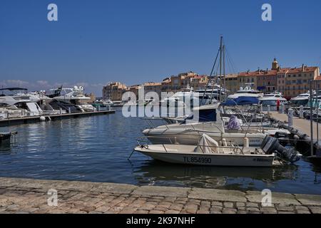 Saint-Tropez, Frankreich - 8. August 2022 - Luxusyachten, Boote und Segelboote säumen den Hafen gegenüber von Geschäften und Cafés in der Altstadt Stockfoto