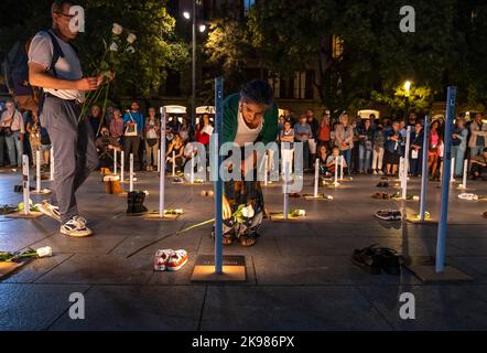 Barcelona, Spanien. 26. Oktober 2022. Zwei Menschen werden gesehen, wie sie weiße Rosen auf die Namen von Obdachlosen legen, die im Jahr 2022 starben, einige davon auf den Straßen. Das soziale Unternehmen Fundación Arrels hat die Batecs de Llum (Lichtschläge)-Veranstaltung vor der Kathedrale von Barcelona genannt, um an die 80 Obdachlosen zu erinnern, die in den letzten 12 Monaten in Barcelona starben, 16 von ihnen auf der Straße. Kredit: SOPA Images Limited/Alamy Live Nachrichten Stockfoto