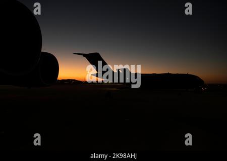 Die Sonne geht über einem 62d Airlift Wing C-17 Globemaster III Flugzeug auf der Fluglinie auf dem Mountain Home Air Force Base, Idaho, 18. Oktober 2022 auf. Neben Luftaufzugsbetrieben führte Team McChord auch Frachten- und Personalverarbeitung, chemische, biologische, radiologische und nukleare sowie Force Protection-Szenarien, Kommunikations- und Verbindungsverschlechterungsereignisse und Krisenszenarien während der Übung Rainier war 22B vom 6. Bis 22. Oktober durch. (USA Foto der Luftwaffe von Staff Sgt. Zoe Thacker) Stockfoto