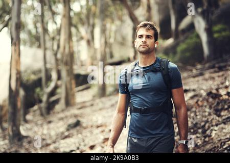 Hes hat die Spur in seinem Visier. Ein hübscher junger Mann auf eine Wanderung in den Bergen. Stockfoto