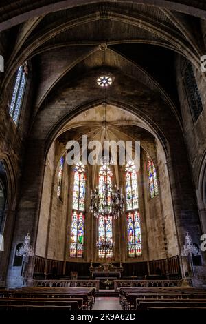 Innenraum, Kreuzrippengewölbe und Glasmalerei der gotischen Stiftskirche Saint Etienne von Capestang, in Südfrankreich (Herault) Stockfoto