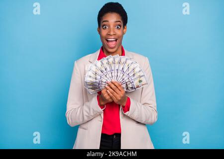 Foto von verrückten erstaunt Business Person halten usd Banknoten tragen Blazer auf blauem Hintergrund isoliert Stockfoto