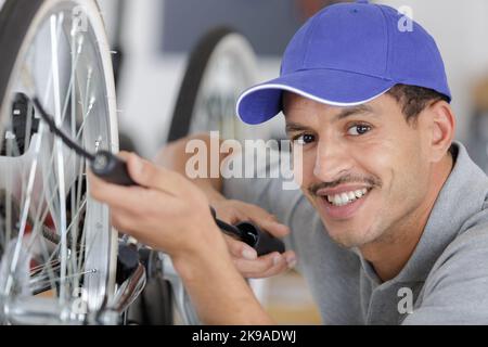 Ein Mann bläst einen Fahrradreifen auf Stockfoto