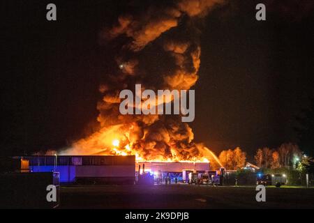 Bads Oeynhausen, Deutschland. 28. Oktober 2022. Über einer Halle für gefährliche Abfälle eines Abfallwirtschaftsunternehmens ist eine große Rauchwolke zu sehen. (To dpa 'gefährliche Abfallhalle in Bad Oeynhausen in Flammen') Quelle: Lino Mirgeler/dpa/Alamy Live News Stockfoto