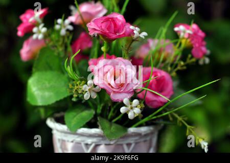 Kunststoff-Blumenarrangements in verschiedenen Farben in Töpfen selektiven Fokus Stockfoto